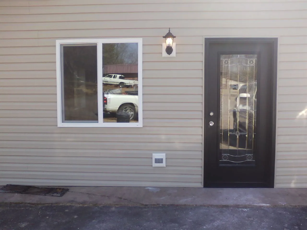 New siding, window and entry door on the side of an addition in Center Rutland