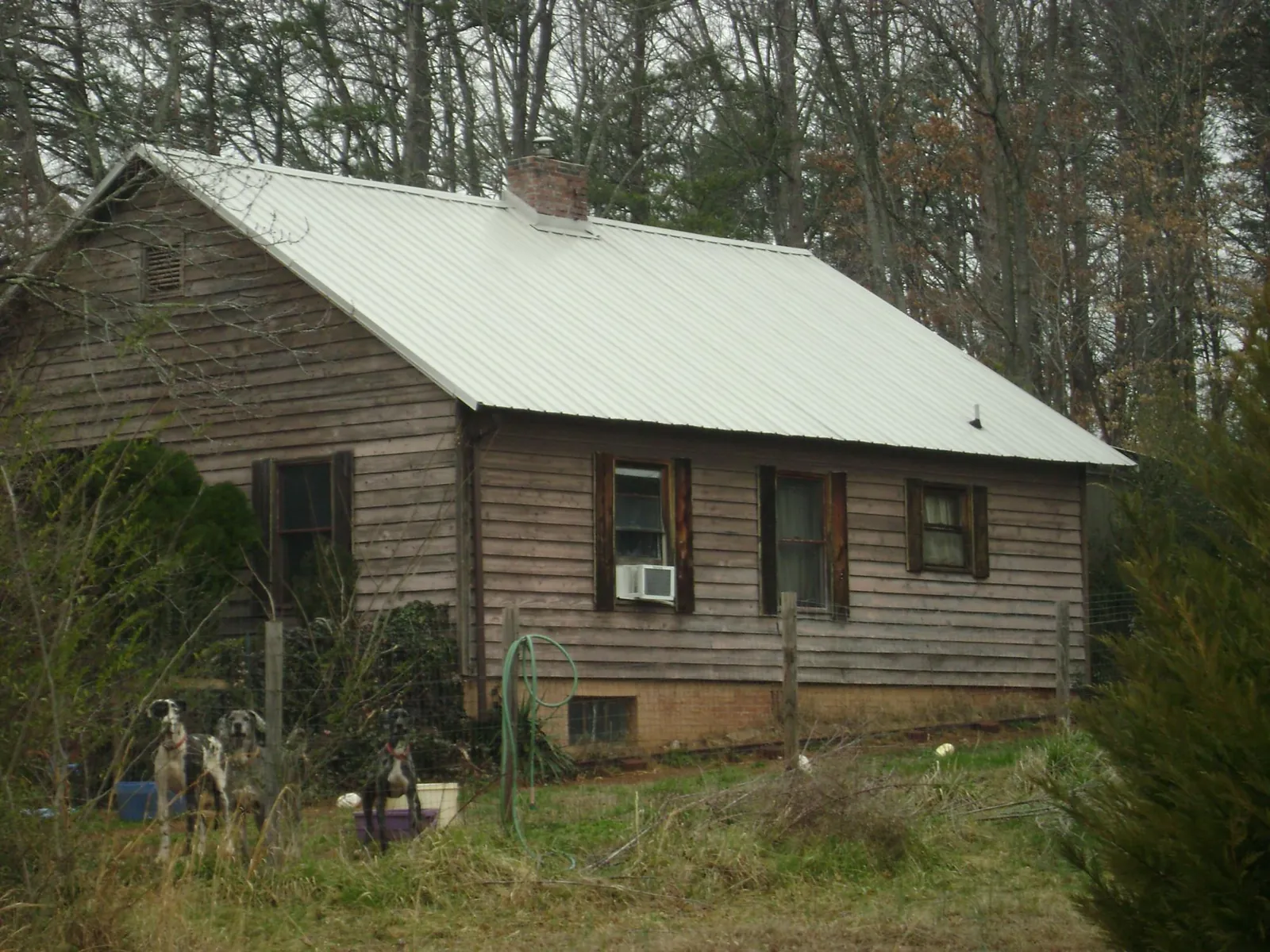 White metal roof on an old wood sided farmhouse, from a Metal Roof Installation job in Center Rutland
